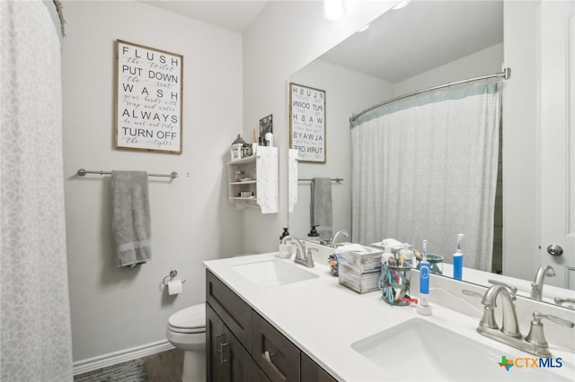 bathroom with vanity, hardwood / wood-style floors, and toilet