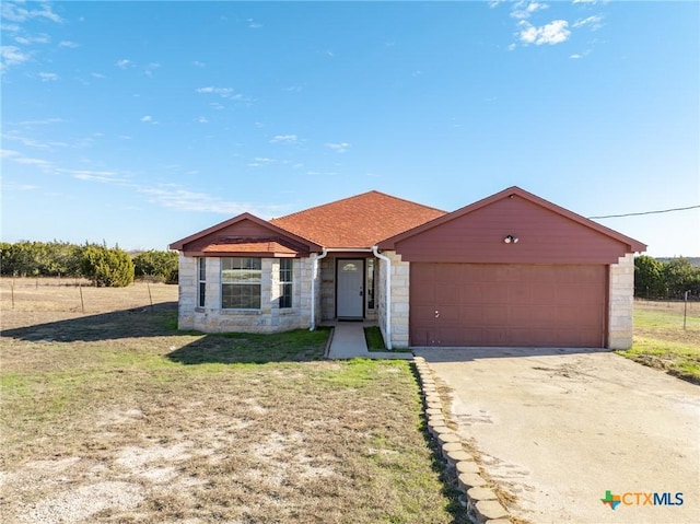 view of front facade with a garage and a front lawn