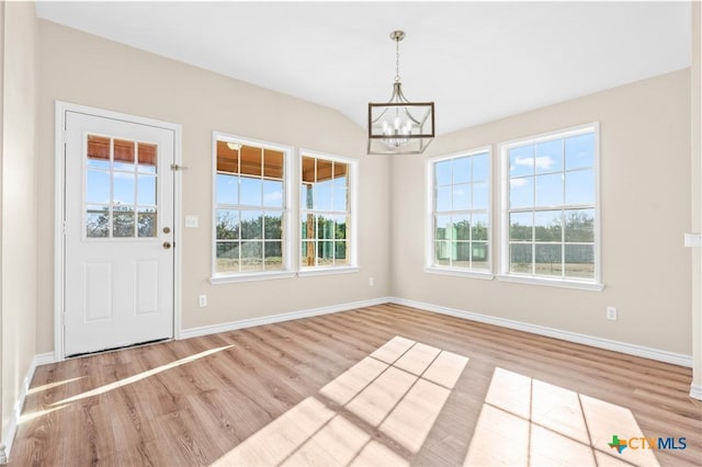 interior space featuring a notable chandelier and light wood-type flooring