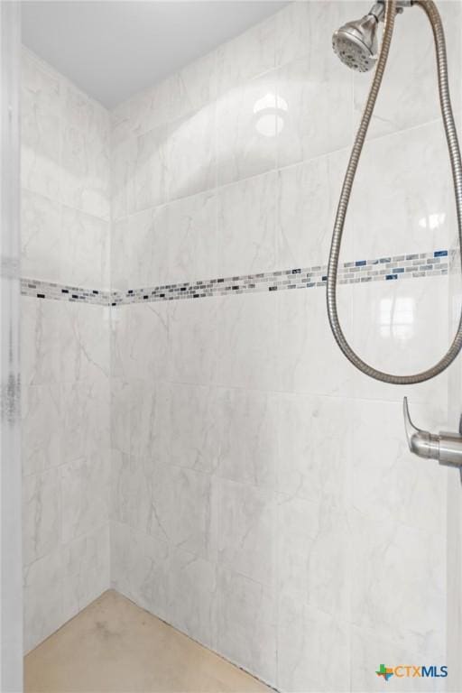 bathroom with tiled shower