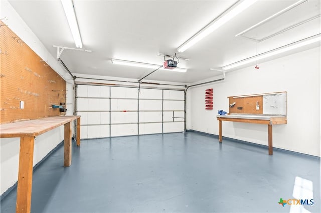 garage featuring a workshop area and a garage door opener