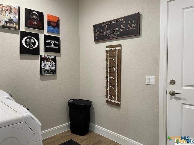 laundry room with wood-type flooring and independent washer and dryer