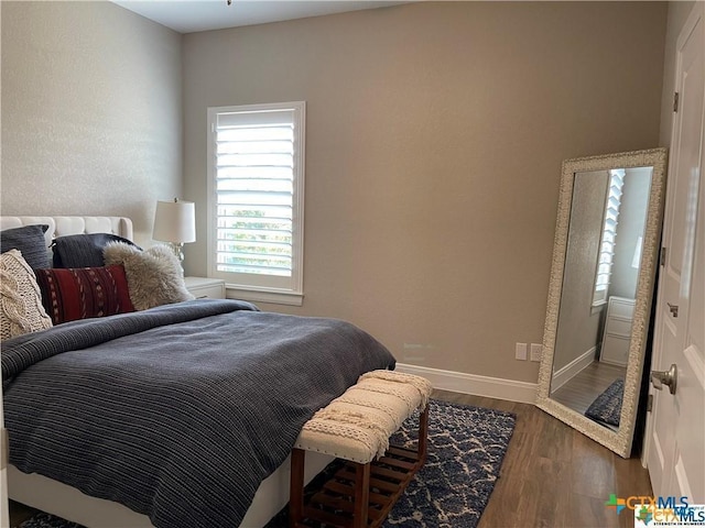 bedroom with hardwood / wood-style floors