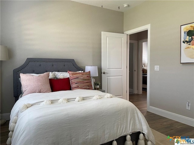 bedroom featuring dark wood-type flooring