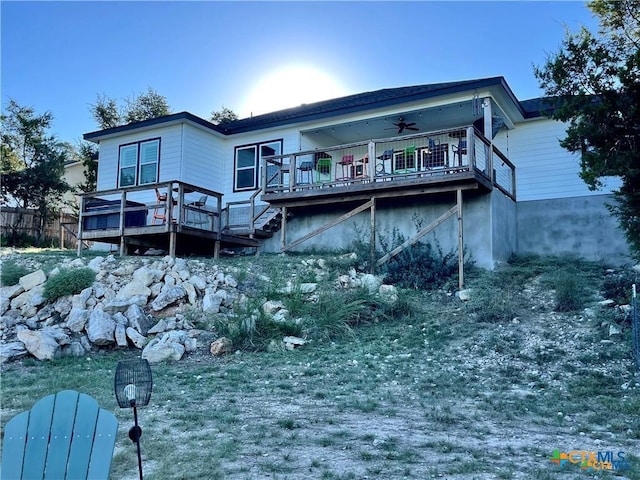 rear view of house with ceiling fan and a deck