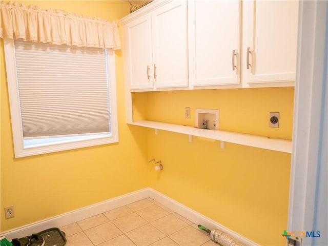 washroom with baseboards, hookup for a washing machine, cabinet space, light tile patterned floors, and hookup for an electric dryer