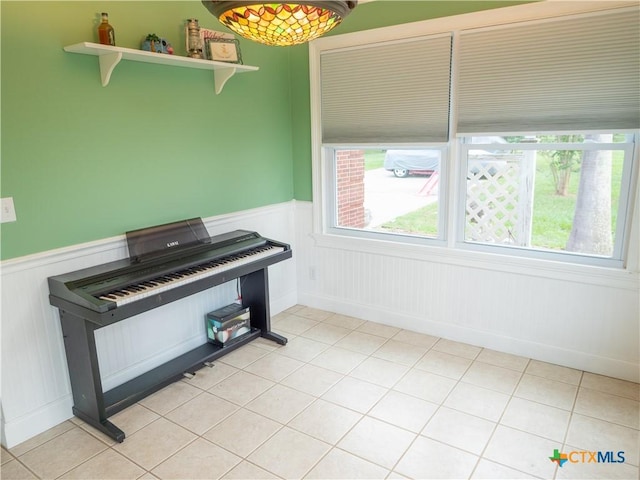 interior space featuring wainscoting and light tile patterned floors