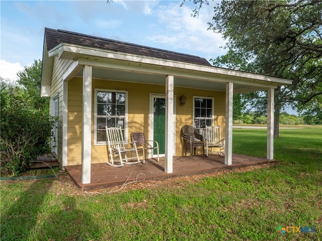 view of outdoor structure with covered porch