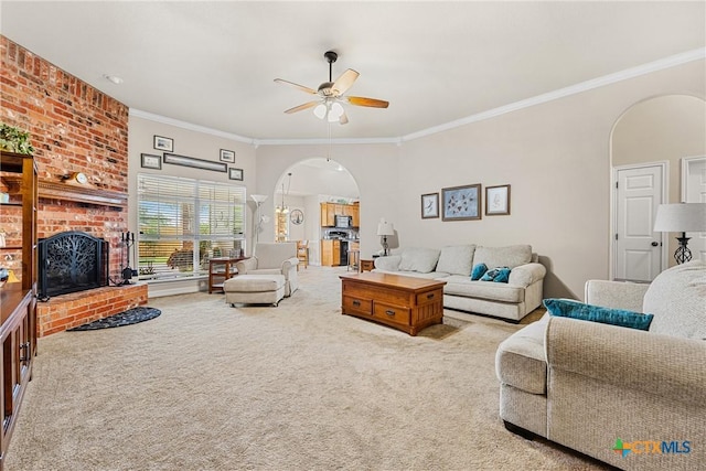 1907 Merlin Dr, Harker Heights, TX 76548 - carpeted living room with arched walkways, ceiling fan, a brick fireplace, and ornamental molding