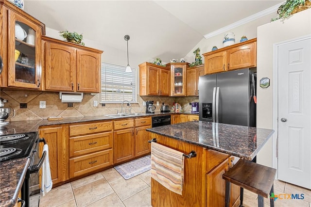 1907 Merlin Dr, Harker Heights, TX 76548 - kitchen with stainless steel fridge with ice dispenser, a sink, vaulted ceiling, brown cabinetry, and light tile patterned floors