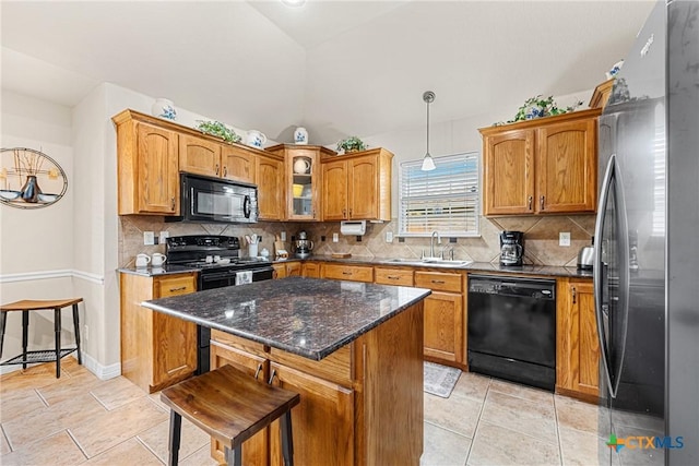 1907 Merlin Dr, Harker Heights, TX 76548 - kitchen with black appliances, a sink, a center island, brown cabinets, and vaulted ceiling