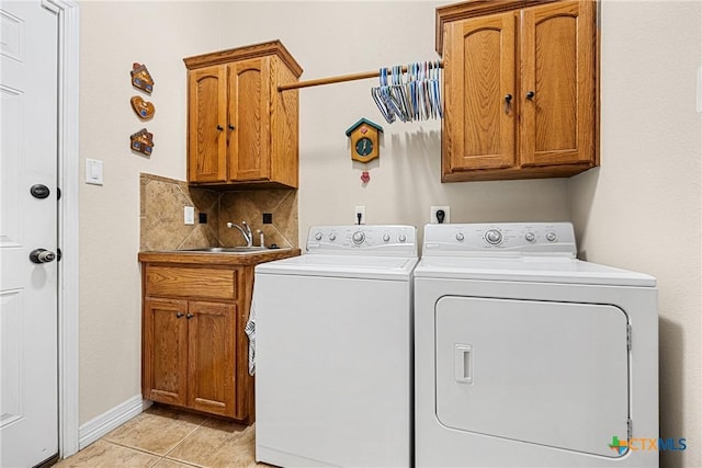 1907 Merlin Dr, Harker Heights, TX 76548 - laundry area with cabinet space, washer and clothes dryer, light tile patterned floors, and baseboards