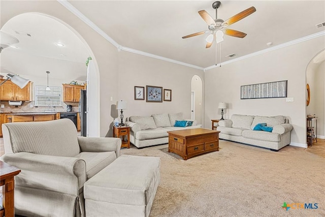 1907 Merlin Dr, Harker Heights, TX 76548 - living room with arched walkways, ceiling fan, crown molding, light colored carpet, and baseboards