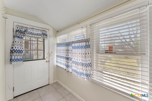 540 Rigsby Ave, San Antonio, TX 78210 - doorway to outside with vaulted ceiling, light tile patterned floors, baseboards, and plenty of natural light