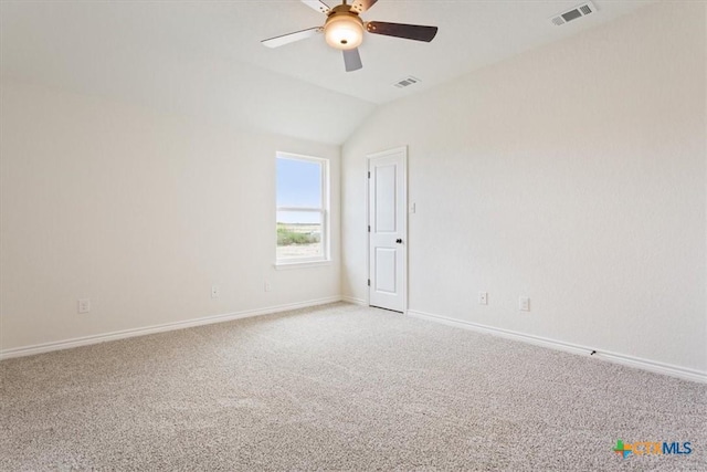 carpeted spare room featuring lofted ceiling and ceiling fan