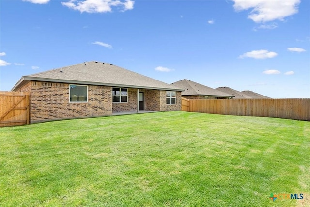 rear view of property with a yard