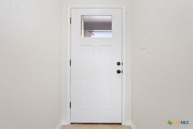 entryway featuring light tile patterned flooring