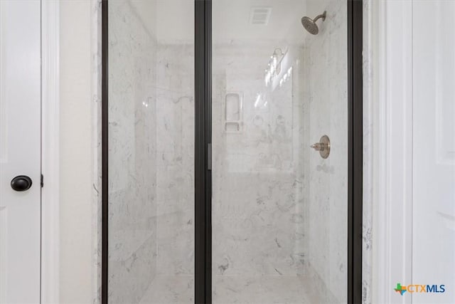 details featuring a shower with shower door