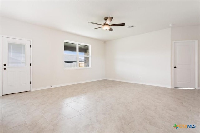 tiled empty room featuring ceiling fan