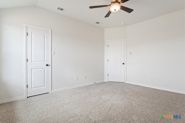 carpeted empty room featuring ceiling fan and vaulted ceiling