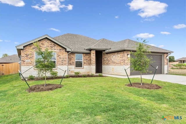 ranch-style house with a garage and a front yard