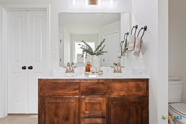 bathroom with toilet and vanity