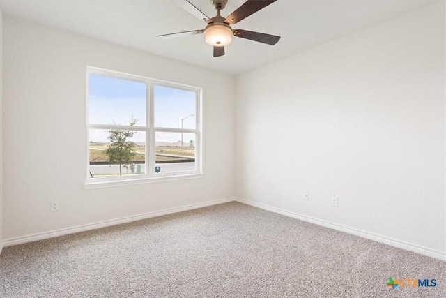 carpeted spare room featuring ceiling fan