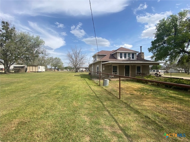 view of yard with an outbuilding and a storage shed