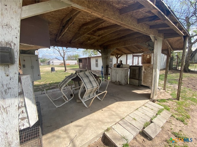 view of patio featuring an outbuilding and an exterior structure