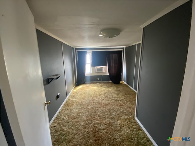 hallway with baseboards, ornamental molding, cooling unit, and carpet