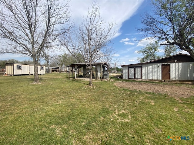 view of yard featuring an outbuilding and an outdoor structure