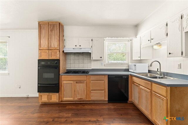 809 S 13th St, Copperas Cove, TX 76522 - kitchen with black appliances, a warming drawer, a sink, under cabinet range hood, and dark wood-style floors