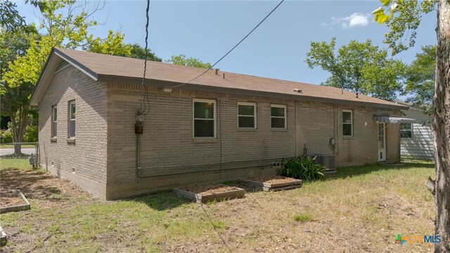 809 S 13th St, Copperas Cove, TX 76522 - view of home's exterior with brick siding, a garden, and cooling unit