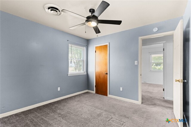 809 S 13th St, Copperas Cove, TX 76522 - unfurnished bedroom featuring multiple windows, carpet floors, and baseboards