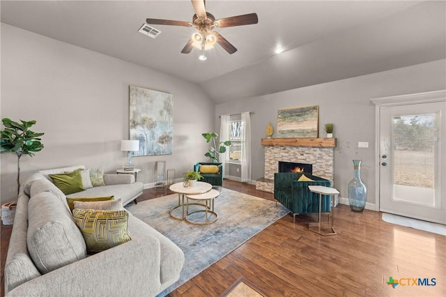 living room with ceiling fan, lofted ceiling, wood-type flooring, and a fireplace