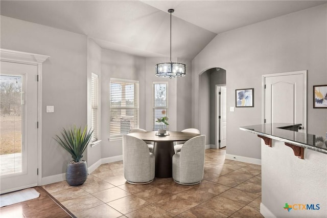 dining room featuring a chandelier and vaulted ceiling