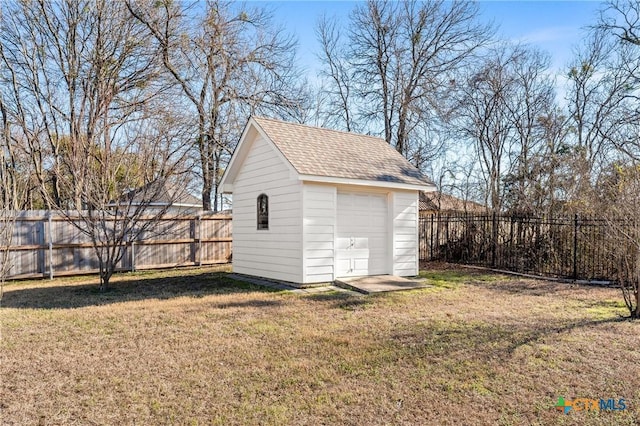 view of outdoor structure featuring a garage and a lawn