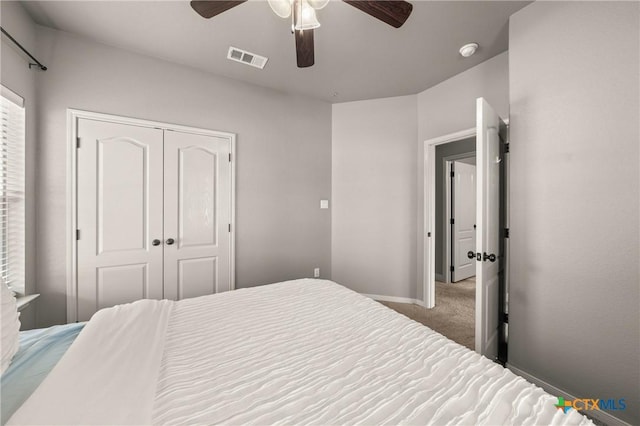 carpeted bedroom with a closet and ceiling fan