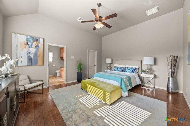 bedroom featuring ceiling fan, lofted ceiling, dark hardwood / wood-style flooring, and connected bathroom