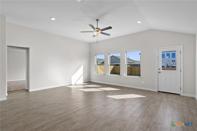 unfurnished living room featuring ceiling fan and vaulted ceiling