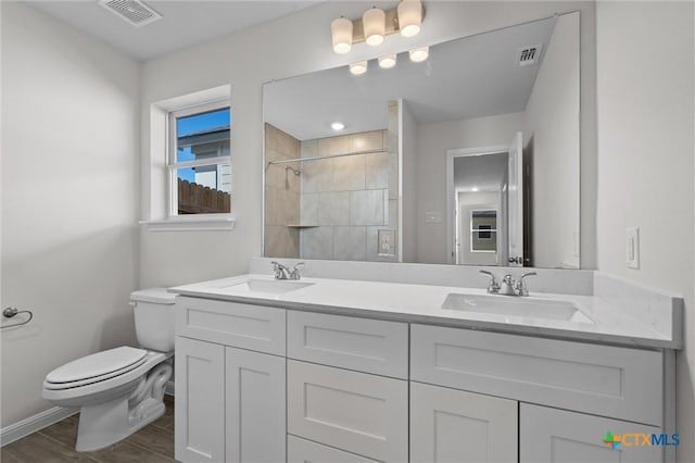 bathroom with vanity, hardwood / wood-style floors, and toilet