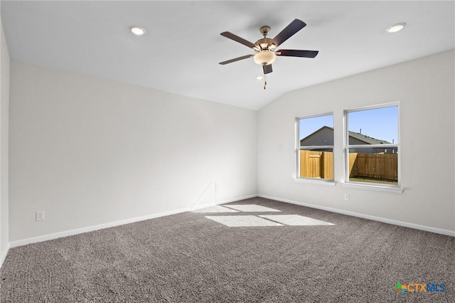 unfurnished room featuring vaulted ceiling, carpet flooring, and ceiling fan