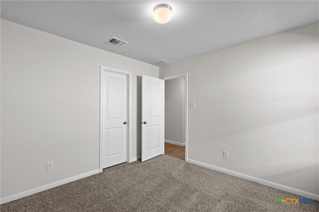 unfurnished bedroom featuring dark colored carpet