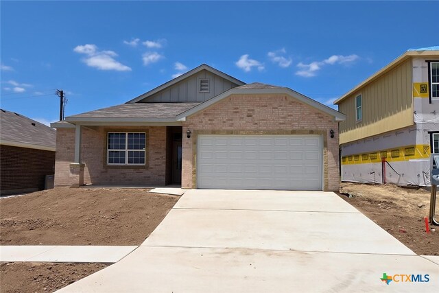 1348 Lindsey Dr, Copperas Cove, TX 76522 - ranch-style house with brick siding, board and batten siding, driveway, and an attached garage