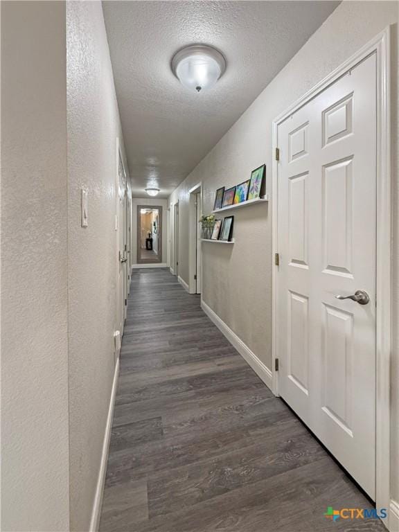 2237 Apache Dr, Harker Heights, TX 76548 - hall featuring a textured ceiling, baseboards, wood finished floors, and a textured wall