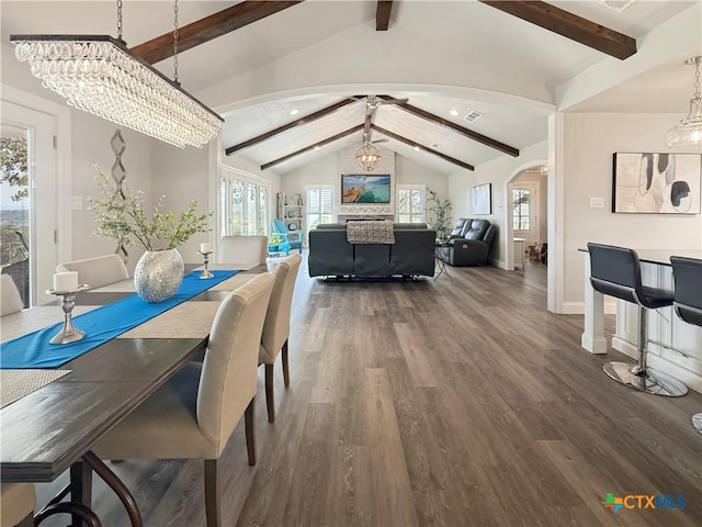 2237 Apache Dr, Harker Heights, TX 76548 - dining space featuring arched walkways, wood finished floors, a chandelier, baseboards, and healthy amount of natural light