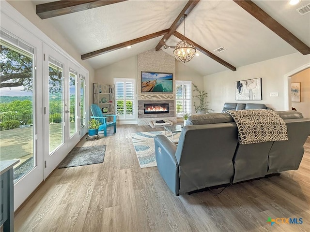 2237 Apache Dr, Harker Heights, TX 76548 - living area with wood finished floors, plenty of natural light, a chandelier, and a large fireplace