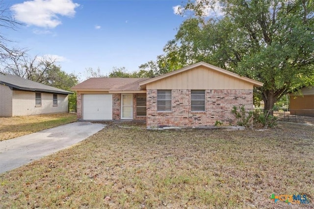 1009 S 29th St, Copperas Cove, TX 76522 - ranch-style house with driveway, brick siding, a garage, and a front lawn