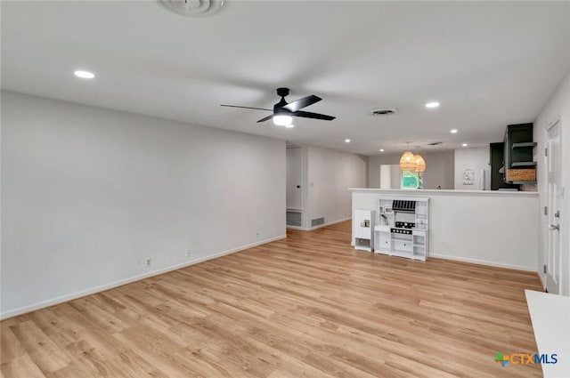 unfurnished living room with ceiling fan and light hardwood / wood-style flooring