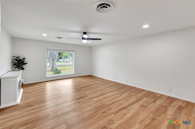 unfurnished room with ceiling fan and light hardwood / wood-style flooring